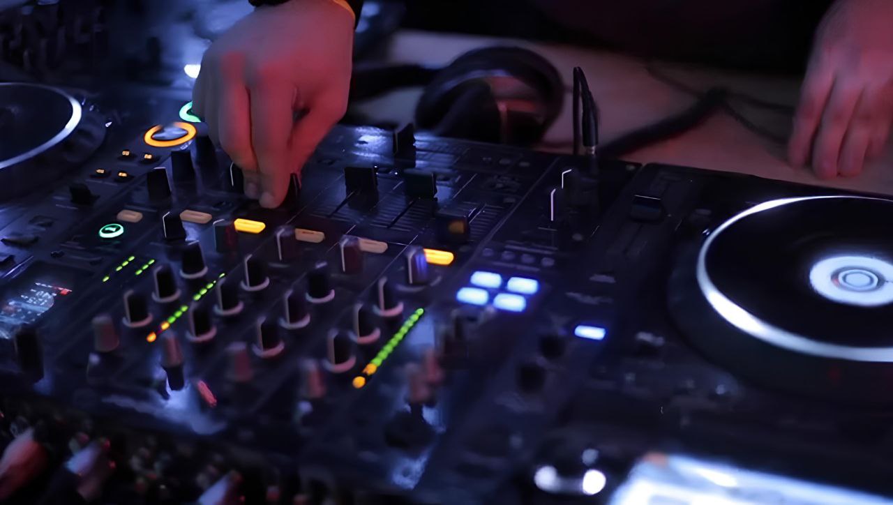 A person using a DJ mixer